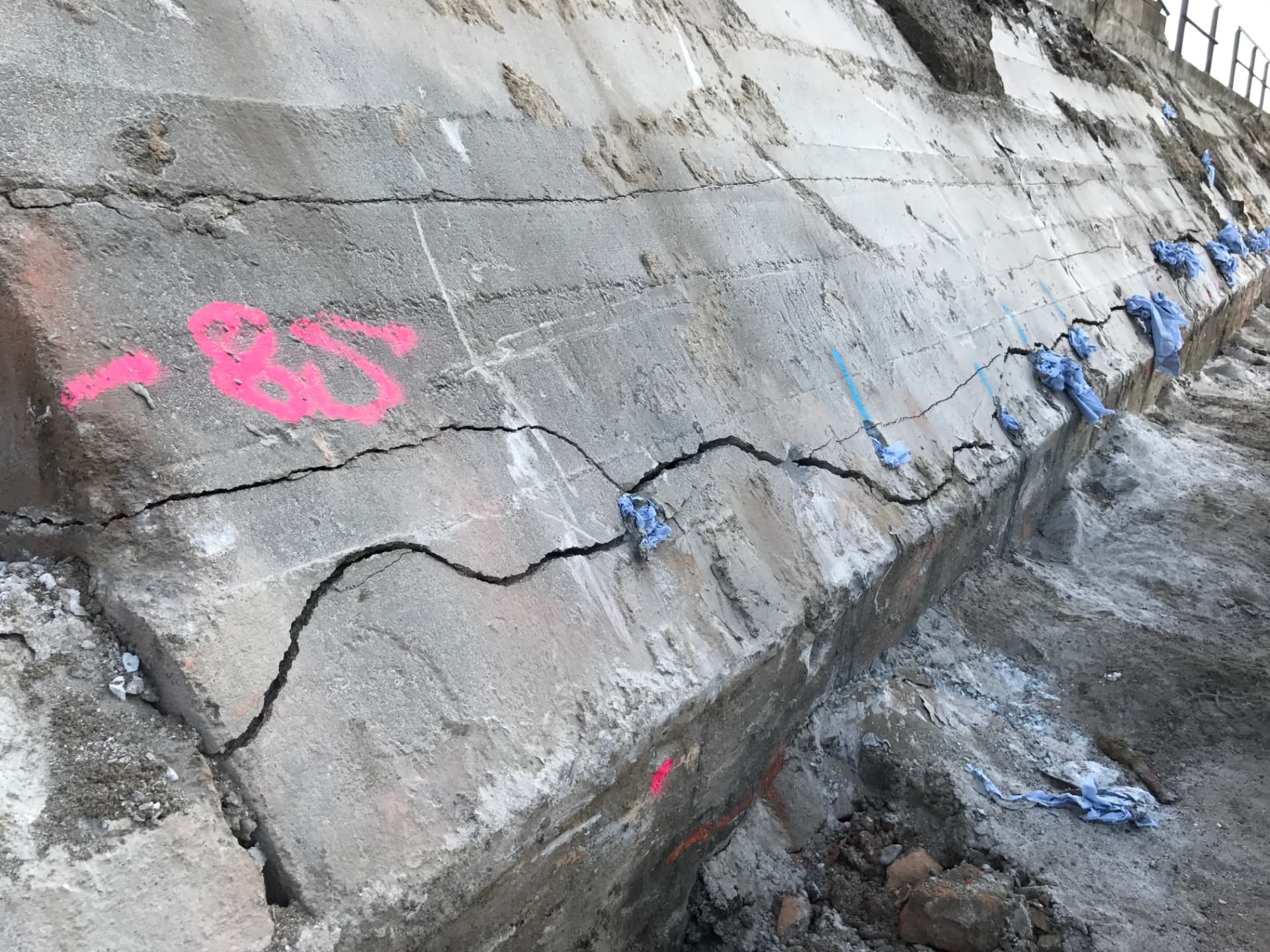 Concrete foundation with drill holes and a continuous crack