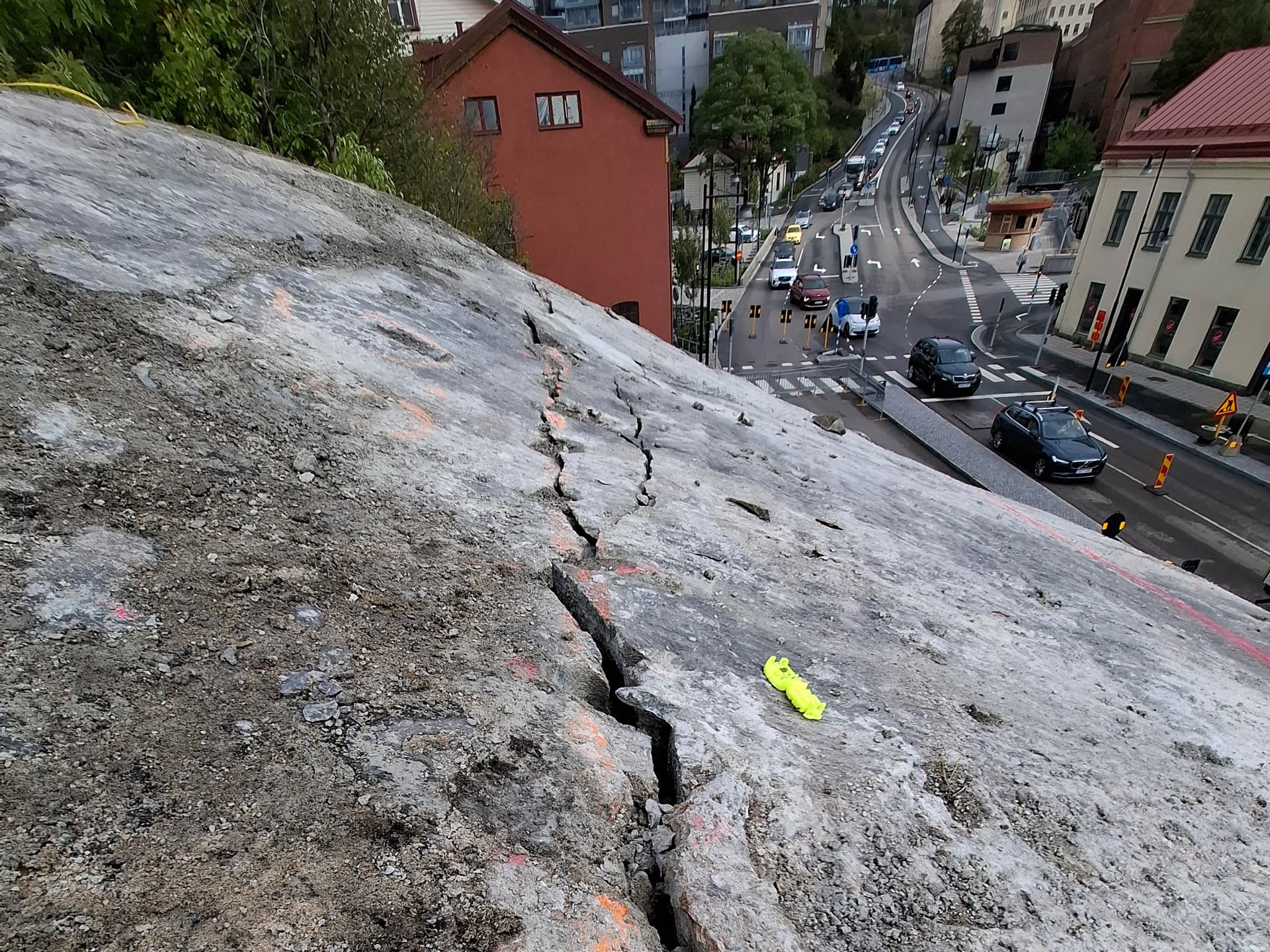 Rock removal directly above a busy road